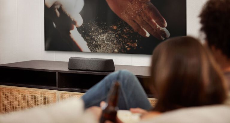 Compact soundbar sitting on a dresser. Compact soundbar sitting on a dresser.