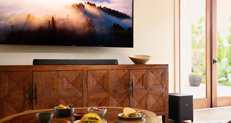 A furnished room with a mounted TV and soundbar. A furnished room with a mounted TV and soundbar.